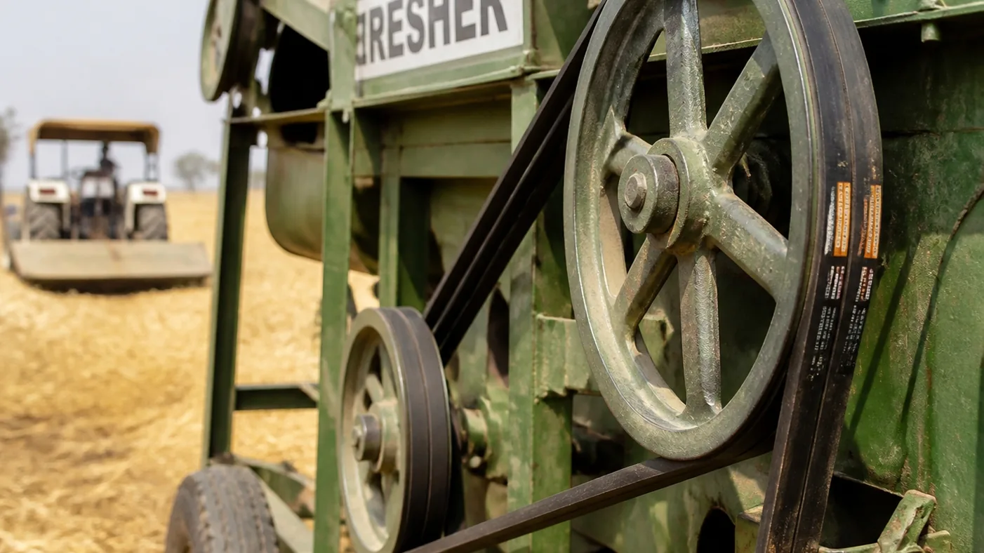Agricultural V belt drive on farm machinery working in a field
